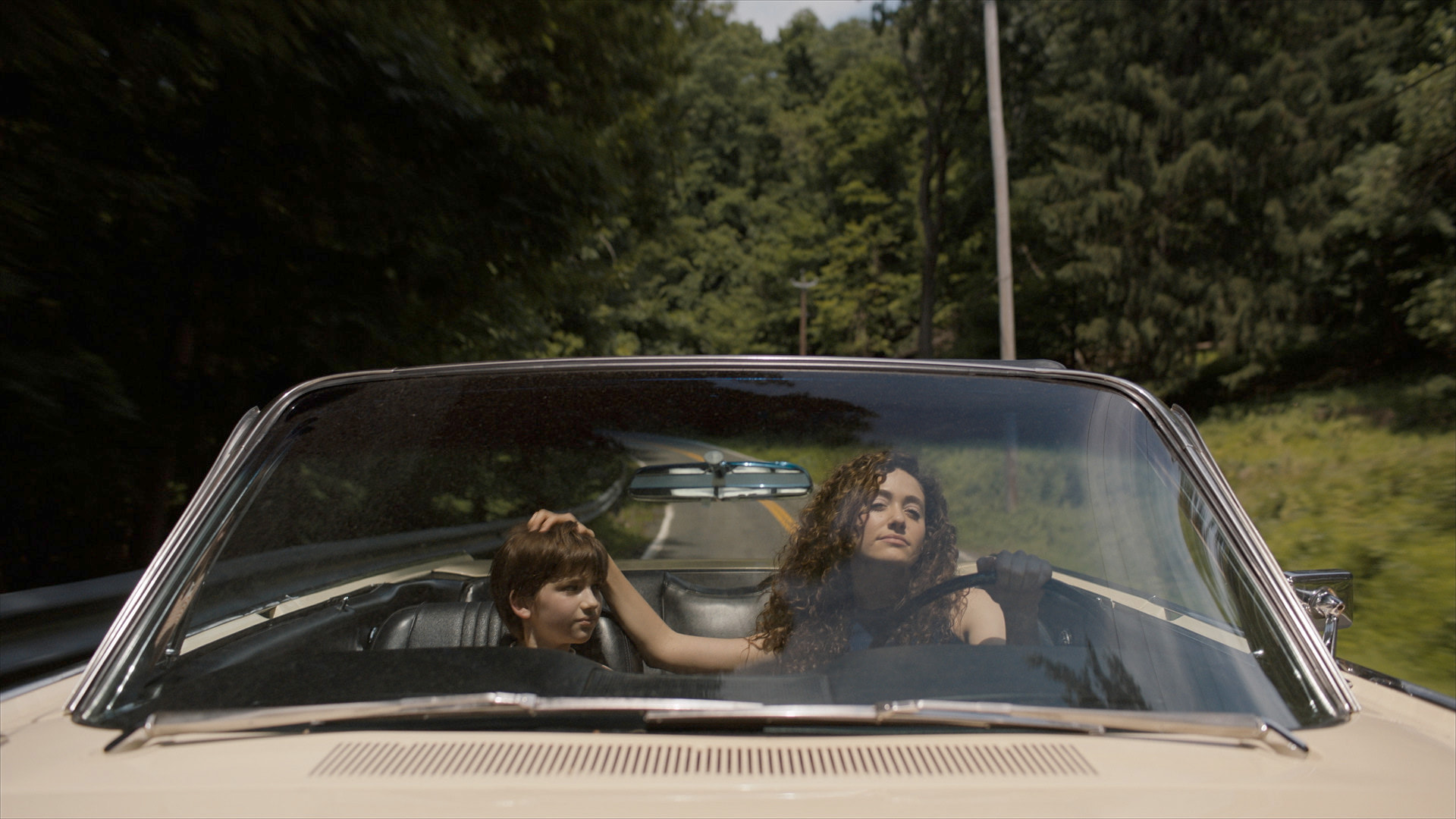 Emmy Rossum in car with child, scene in The Crowded Room